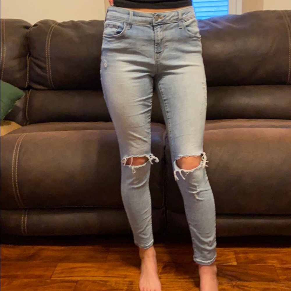 Light wash jeans with holes in the knees